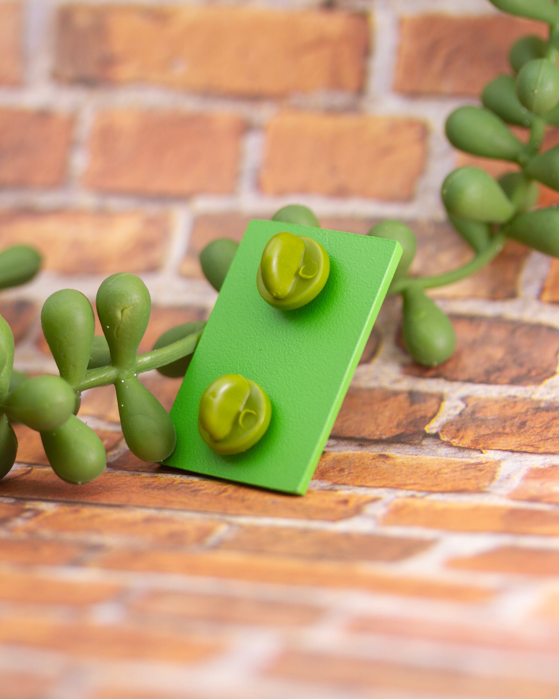 Back of TMNT enamel pin with 2 green rubber backings.